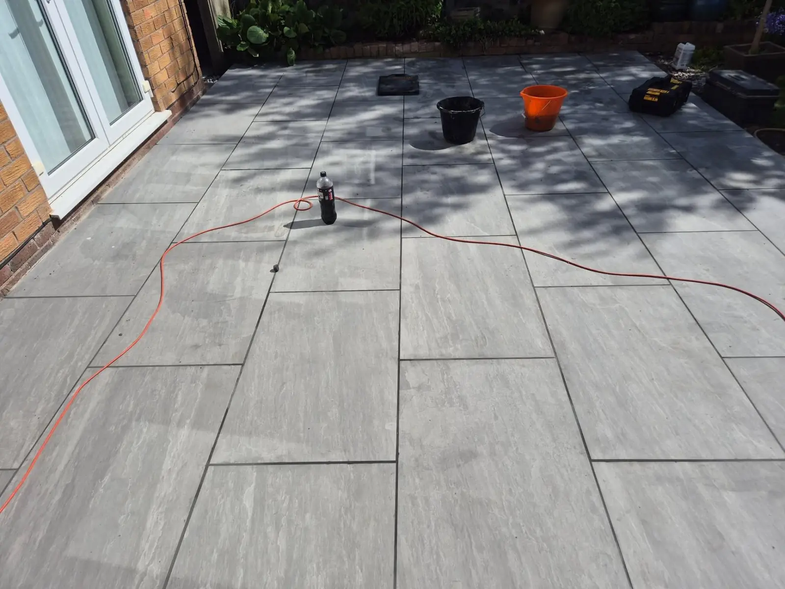 Freshly laid porcelain patio, rinsed and ready