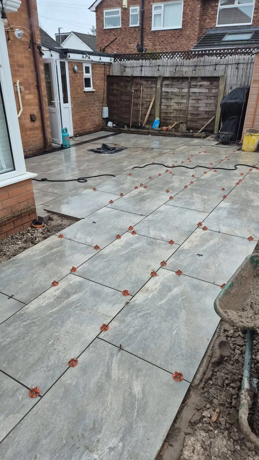 Large patio mid-lay with tile spacers throughout