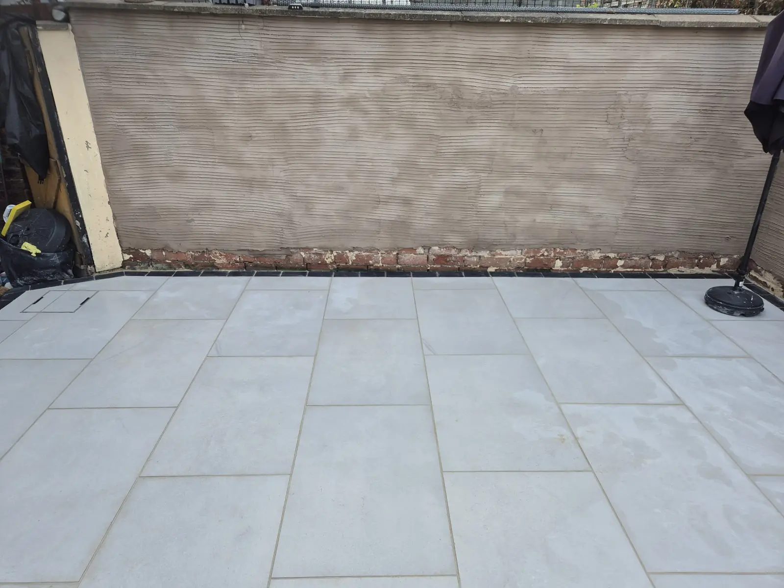 Finished patio with inspection cover cut neatly into the paving