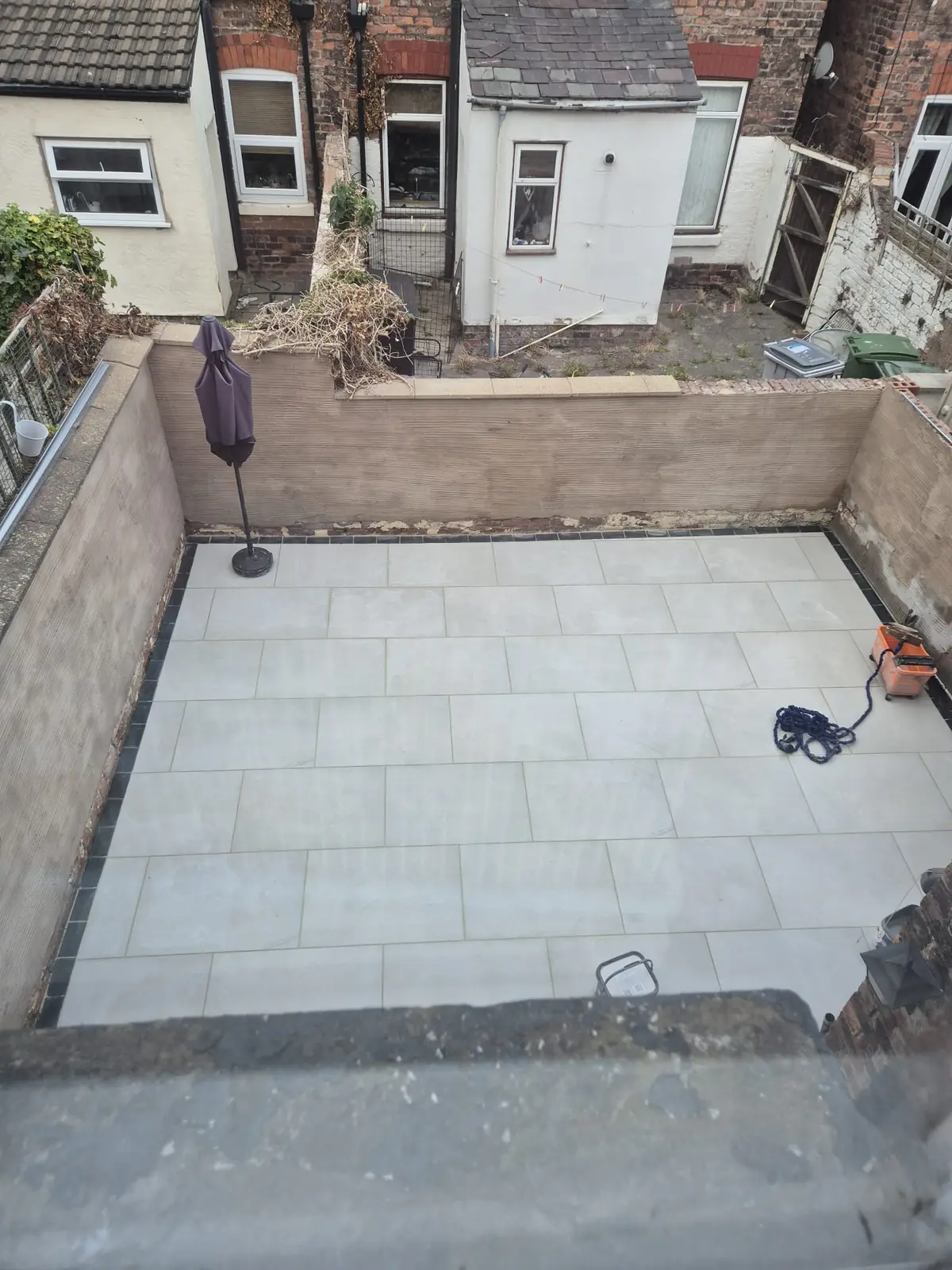 Aerial view of a fully paved enclosed back yard