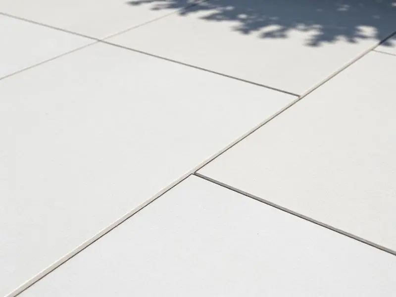 white porcelain slabs with clean grey jointing compound filling the joints
